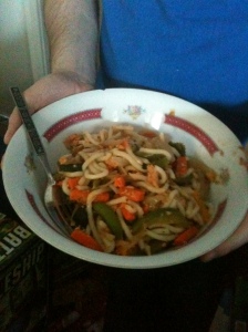 My husband is holding the bowl of stir-fry (or whatever you want to call it.)